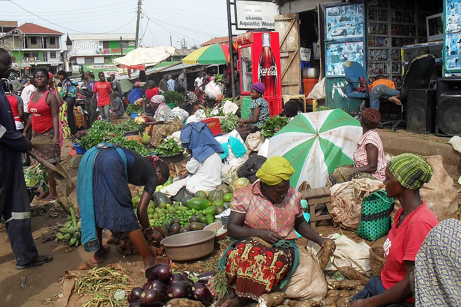 The photo shows a bustling market in Uganda.